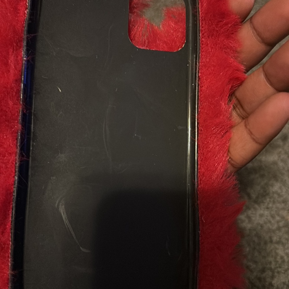 This is a fuzzy red case for a iPhone 11 pro max. There is a few little scratch. - Picture 3 of 4
